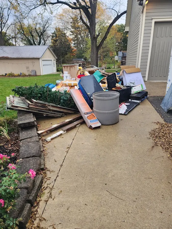 Dumpster being loaded with debris for 12 Yard Dumpster Rental in Brighton